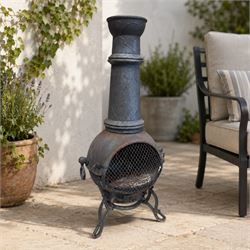 Cast iron garden chiminea, with mesh front spark guard, flue chimney on three splayed legs...