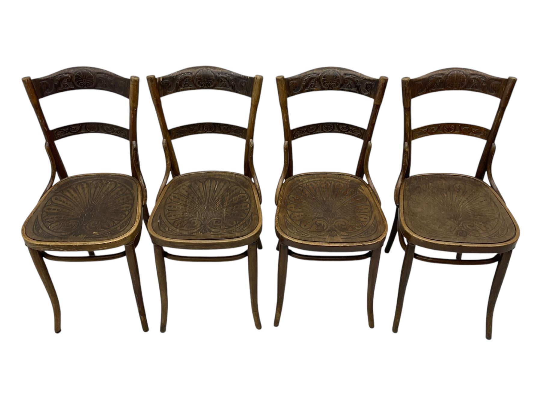 Jacob & Josef Kohn - set of four early 20th century Austrian bentwood chairs, each with carved decoration to the shaped backrest and shaped seat, on splayed supports with stretchers, marked with the manufacturer's stamp and paper label beneath