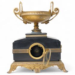 French- late 19th century 8-day mantle clock in an imposing Belgium slate case with gilt metal ornamentation. Stepped rectangular case with an angled top and square plinth surmounted by an oval shaped gilt urn with scroll handles, case with continuous strapwork and oval medallions displaying portraits from classical antiquity, raised on a gilt metal base with splayed feet, conforming unenclosed slate dial with gold incised Roman numerals and brass Fleur de Lis hands, Parisian twin train rack striking movement with pendulum regulation, striking the hours and half hours on a bell. With pendulum.