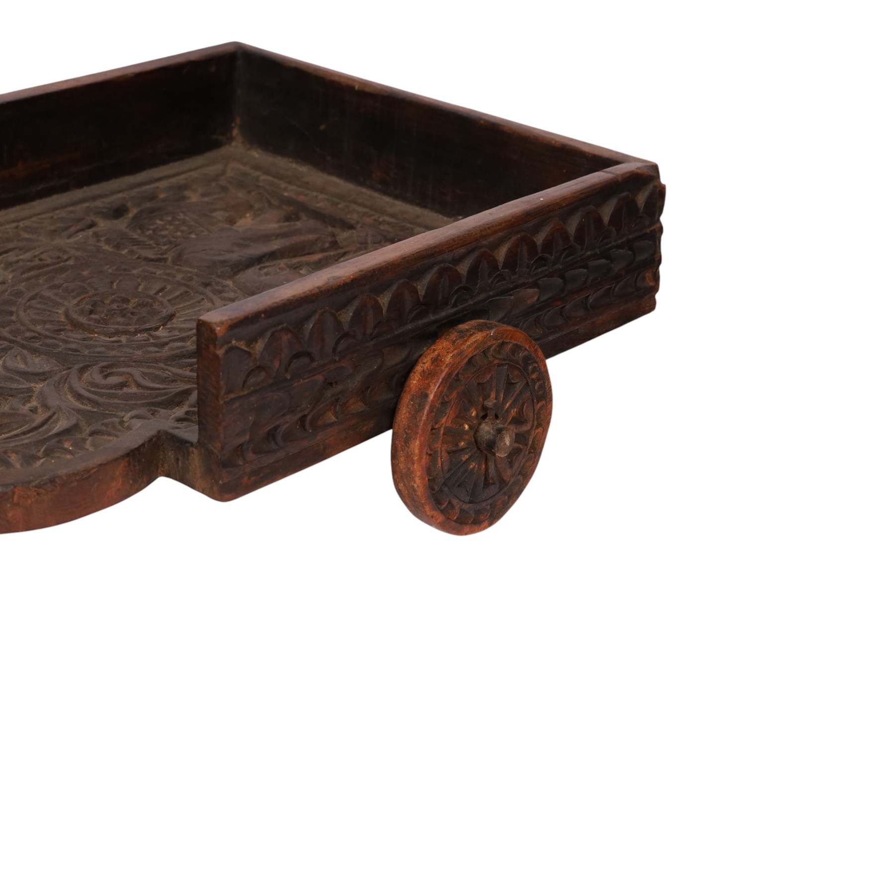 Indian carved wooden tray on wheels, the front carved as a horses head, the cart with foliate details, H28cm