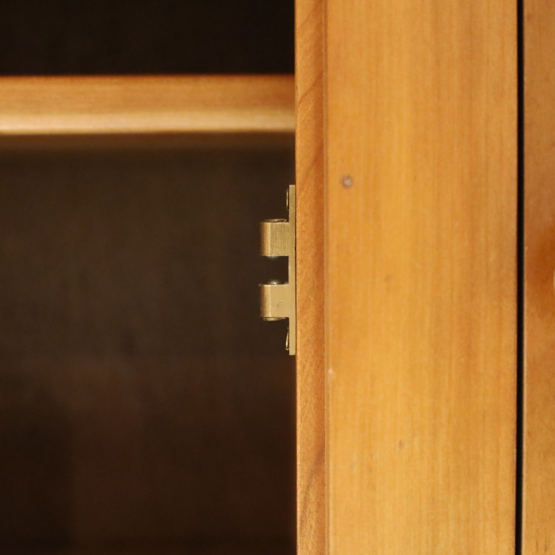 Traditional cherrywood sideboard, rectangular top above three fielded panelled drawers, three cupboard doors with triple panelled doors, brass knobs and hinges, tapered supports
