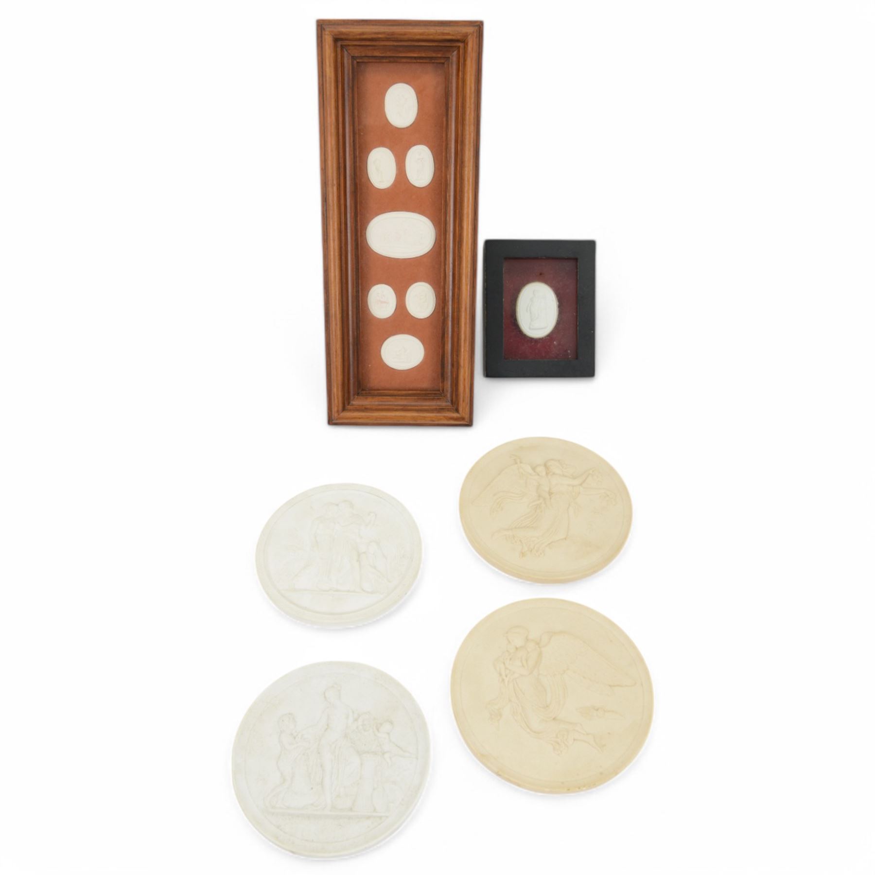 Seven plaster medallions within a wooden frame, together with another framed medallion, pair of Royal Copenhagen bisque porcelain circular plaques and two other plaques  