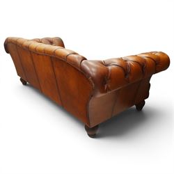Tetrad - 'Oskar' grande three-seat sofa, Chesterfield shape with rolled arms over serpentine back and front, upholstered in fully buttoned tan leather, raised on reed-moulded feet of globular form