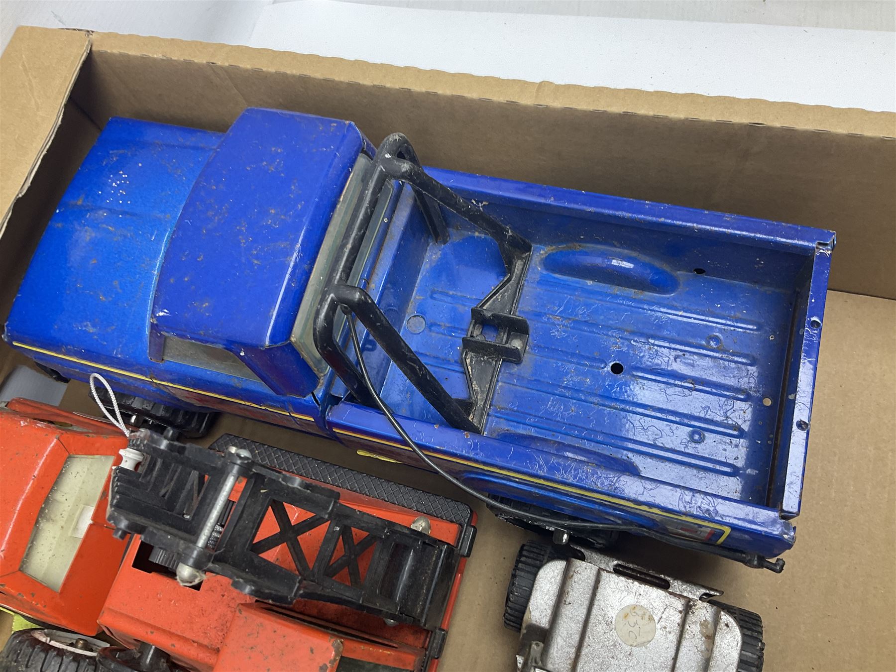 Tonka - fourteen pressed steel vehicles including Pick-up Truck, Tractor Digger, Mobile Crane, Trencher, Beach Buggy, two Bulldozers, Digger, Low Loader, Farm Trucks etc; and small quantity of spare parts (14)