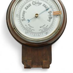 An English 20th century aneroid barometer with a slivered dial and surface mounted mercury thermometer.
