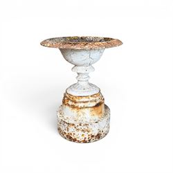 Victorian cast iron garden urn, egg and dart rim with shallow bowl, raised on stepped circular pedestal, finished in weathered white paint 