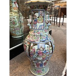 Large pair of 19th century Cantonese famille rose vases, each painted with various courtly scenes, including a display of warriors fighting on horseback before an official and his attendants, double Buddhist lion handles and applied at the shoulders with chilong, the lower band painted with Greek key motif, H58cm (2)