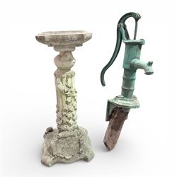 Cast stone bird bath on pedestal with cast iron water pump