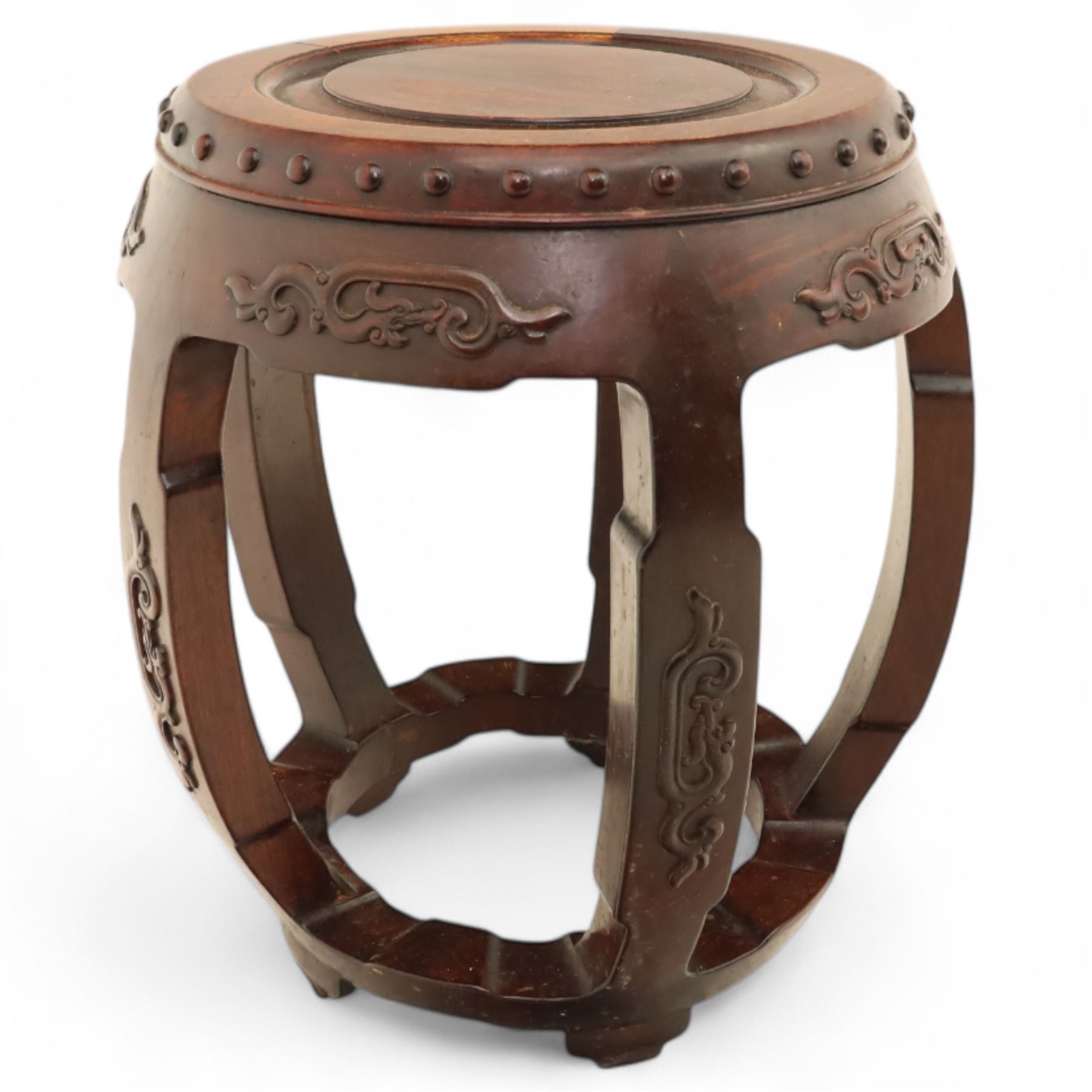 Pair of early 20th century Oriental hardwood barrel seats, of drum form with shaped apron and pierced panels, carved with stylised scrollwork and studded detail to the top