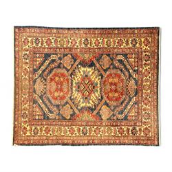 Persian Heriz carpet, the indigo field with bold central medallion in rust red and ivory, ...