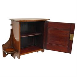 Small Arts & Crafts mahogany wall cupboard, single panelled door enclosing shelf, flanked by two shelves with pierced brackets, with shaped copper fittings and escutcheon 