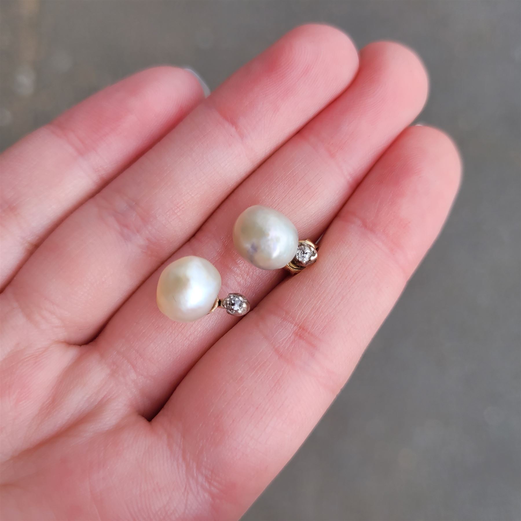 Pair of 19th / early 20th century natural saltwater pearl and diamond earrings, one stud set with a single white / cream pearl, the other with a white / grey / cream pearl, each suspending from a single old cut diamond, total pearl weight approx 4.30 carat