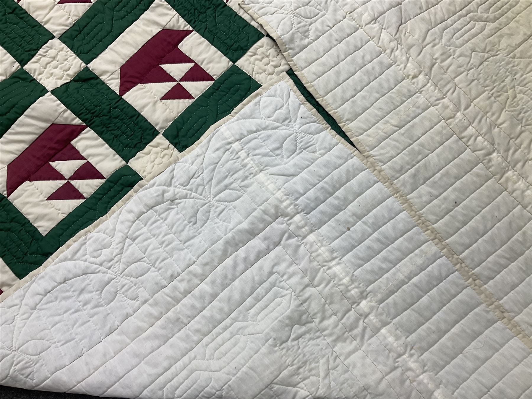 20th century quilt, with repetitive ship design to the centre within a cream red and green boarder, 227cm x 222cm
