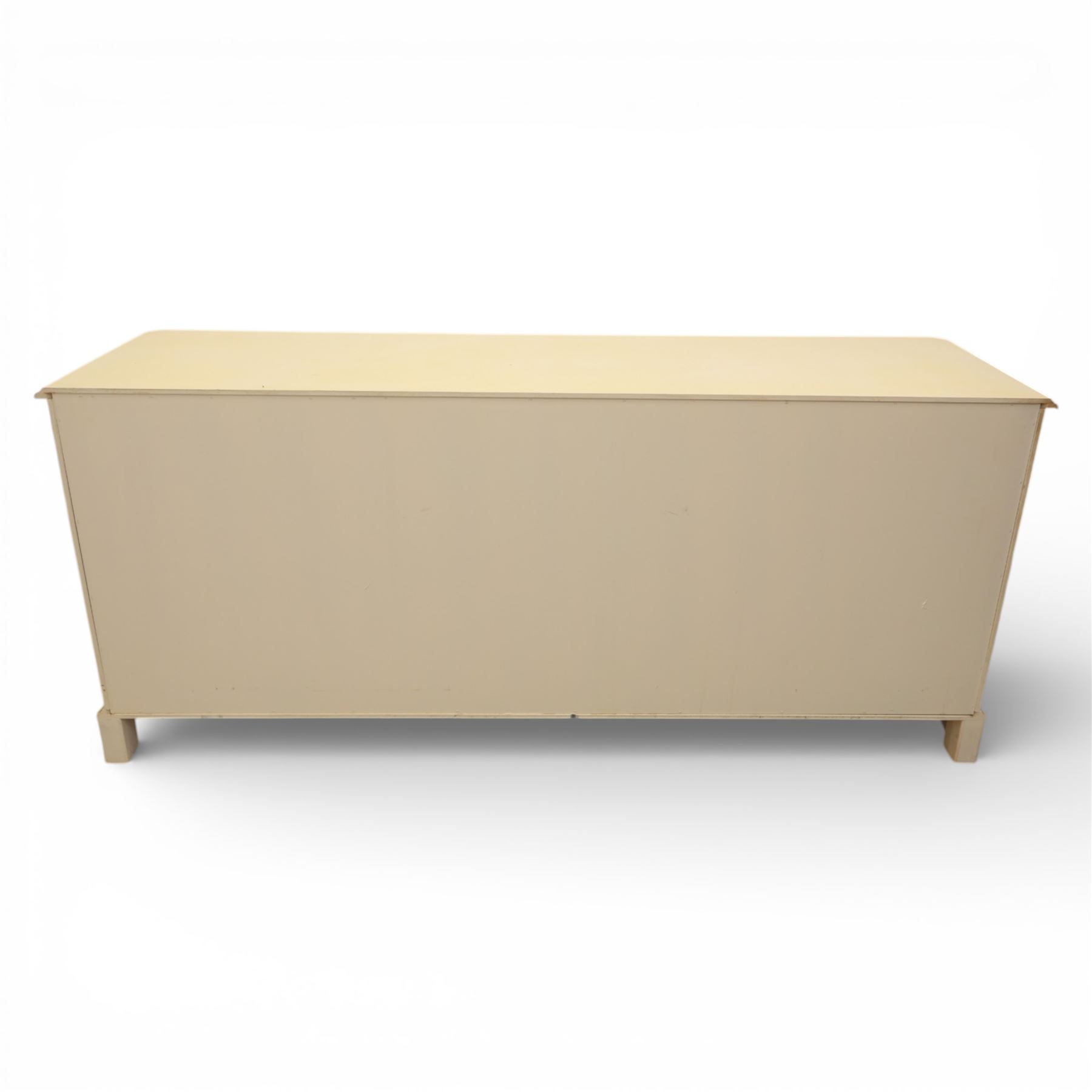 Contemporary French design white painted bedroom suite retailed by Barkers of Northallerton, comprising wide chest fitted with four short and four long drawers with oval brass handles (H 70cm, W 159cm, D 46cm), pair of bedside chests each fitted with three drawers (H 62cm, W 40cm, D 46cm), dressing table fitted with four short drawers and central kneehole with shaped apron (H 79cm, W 131cm, D 46cm) with matching framed wall mounted mirror (H 100cm, W 113cm), and full length standing mirror (H 175cm, W 73cm)