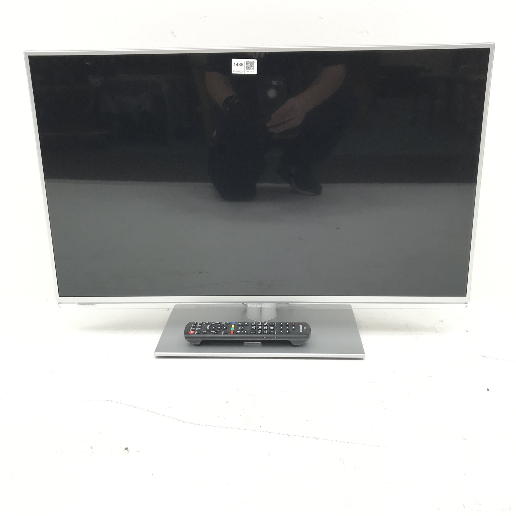 Panasonic TXL32E6B (32”) television and remote control The