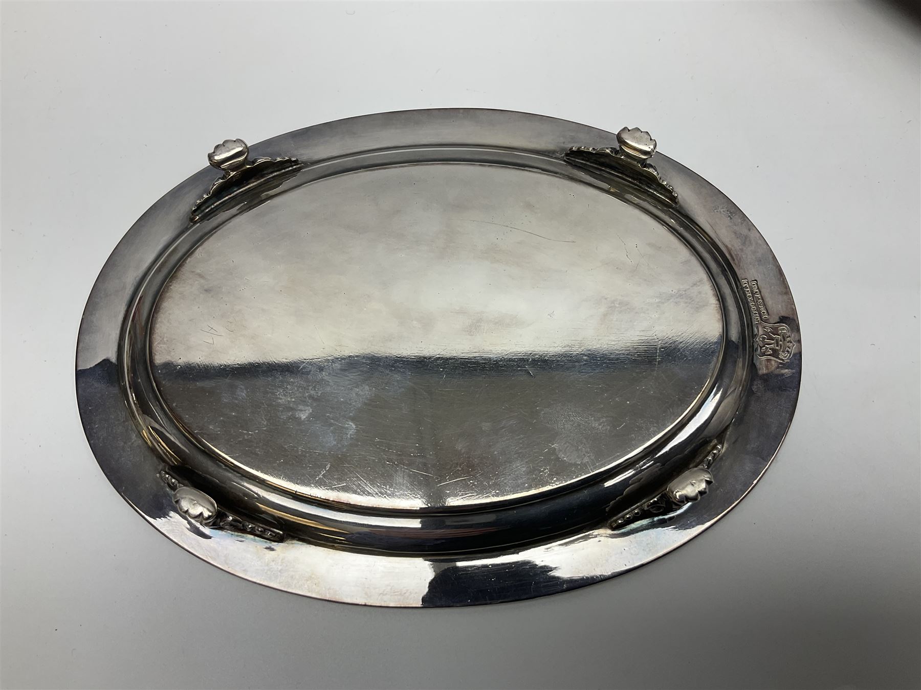 Pair of Mappin and Webb silver plate pierced pedestal bon bon dishes, together with other silver plate comprising teapot stand engraved with lion's head to centre, two cut glass claret jugs, two bottle coasters with acorn decoration, two open salts upon dolphin mounts, tea caddy, three piece cruet set and a large oval tray with pierced sides and upon four ball feet