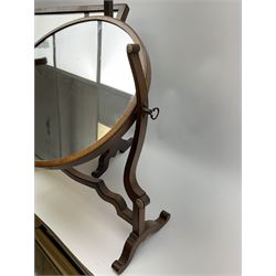 An Edwardian mahogany dressing table mirror, the oval mirror plate in swing frame, upon flared legs linked by stretcher, the frame detailed with turned roundels, H49cm, together with a Victorian mahogany example, H50cm. 