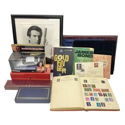 Pierce Brosnan framed picture, James Bond books, Corgi Tomorrow Never Dies BMW 750i model, small number of stamps, empty coin displays and other miscellaneous items