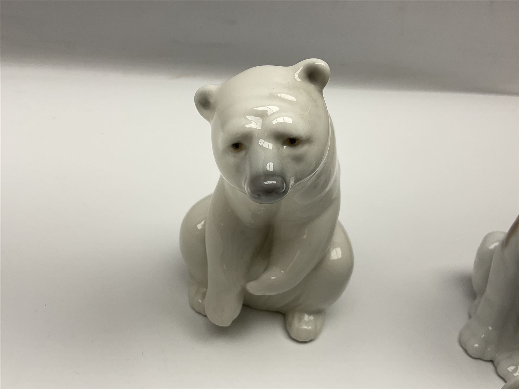 Five Lladro figures, comprising Cat and Mouse no. 5236, That Tickles no. 5888, Gentle Surprise no. 6210, Little Hunter no. 6212 and Resting Polar Bear no. 1208, largest H12cm