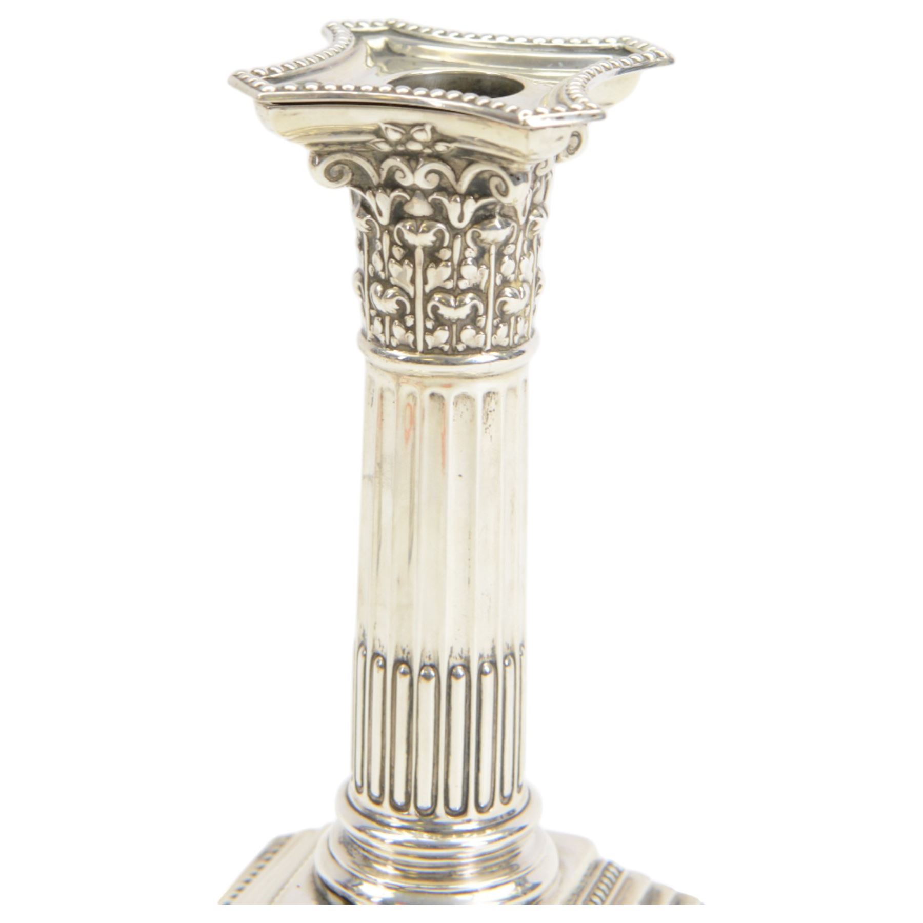 Pair of early 20th century silver Corinthian column candlesticks, upon square stepped filled bases, hallmarked Walter Latham & Son, Sheffield 1913, H16cm