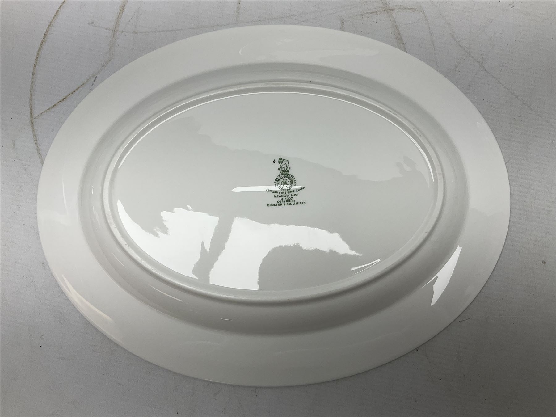 Royal Doulton tea and dinner wares in the Meadow Mist pattern, no H5007, comprising seven dinner plates, eight side plates, two lidded tureens, two jugs, lidded sucrier, oval serving dish, six teacups, seven saucers, seven tea plates and large saucer