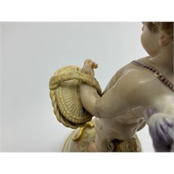 Late 19th/early 20th century Meissen figure of cupid, modelled standing with empty quiver across back, holding a basket in one arm, the other raised to head, upon a naturalistically modelled base detailed with gilt bow,  and marble effect socle base with gilt bands, with blue crossed swords mark beneath, H18.5cm