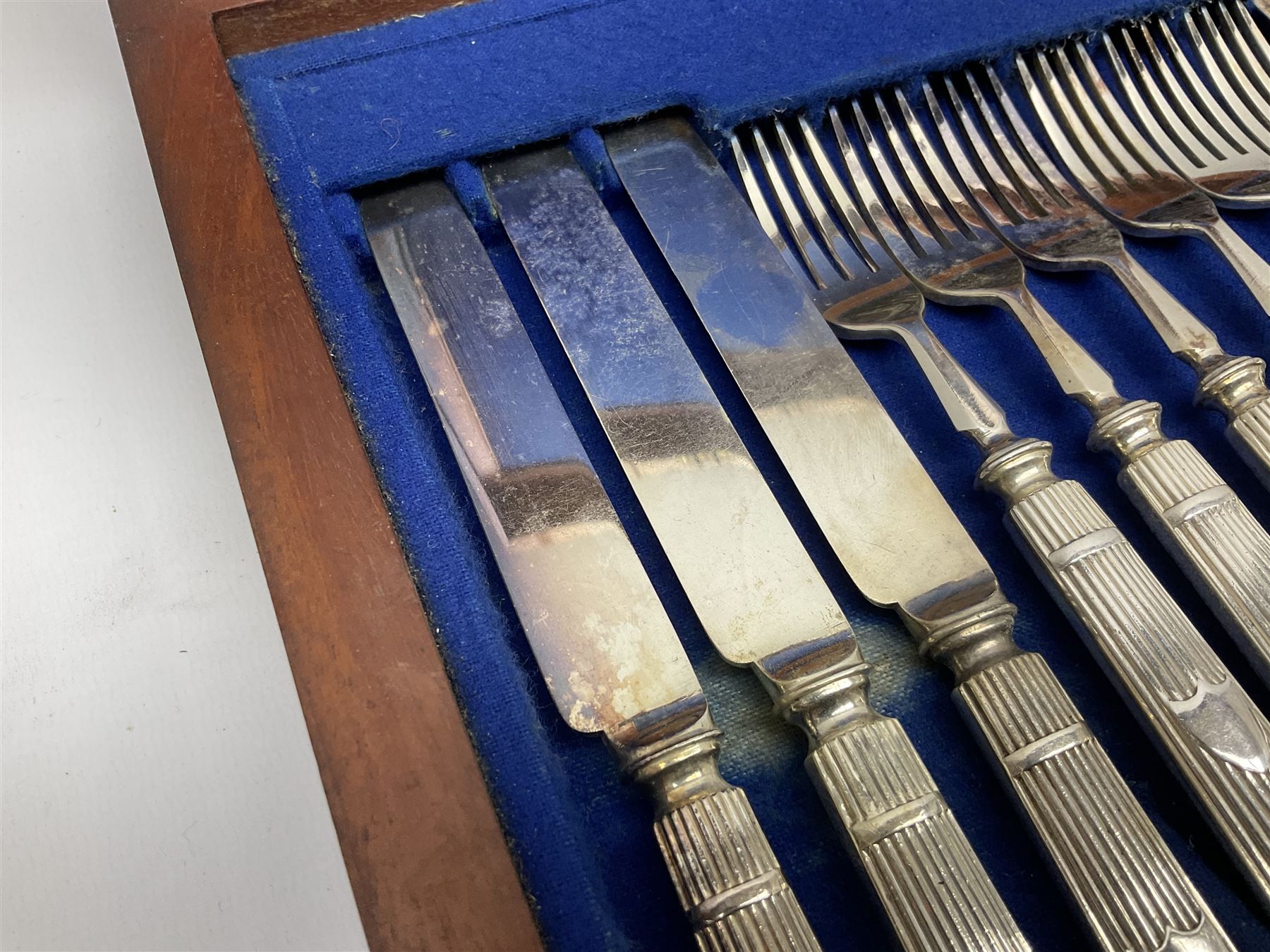 Victorian silver plated dessert set by Elkington & Co for twelve place settings, each reeded handle with vacant cartouche, each with Elkington & Co mark, date letter for 1861, and registration lozenge, contained within a mahogany case with vacant brass cartouche to the hinged cover, opening to reveal a Royal blue baize lined interior with removable tray, case H6cm W29.5cm D26.5cm