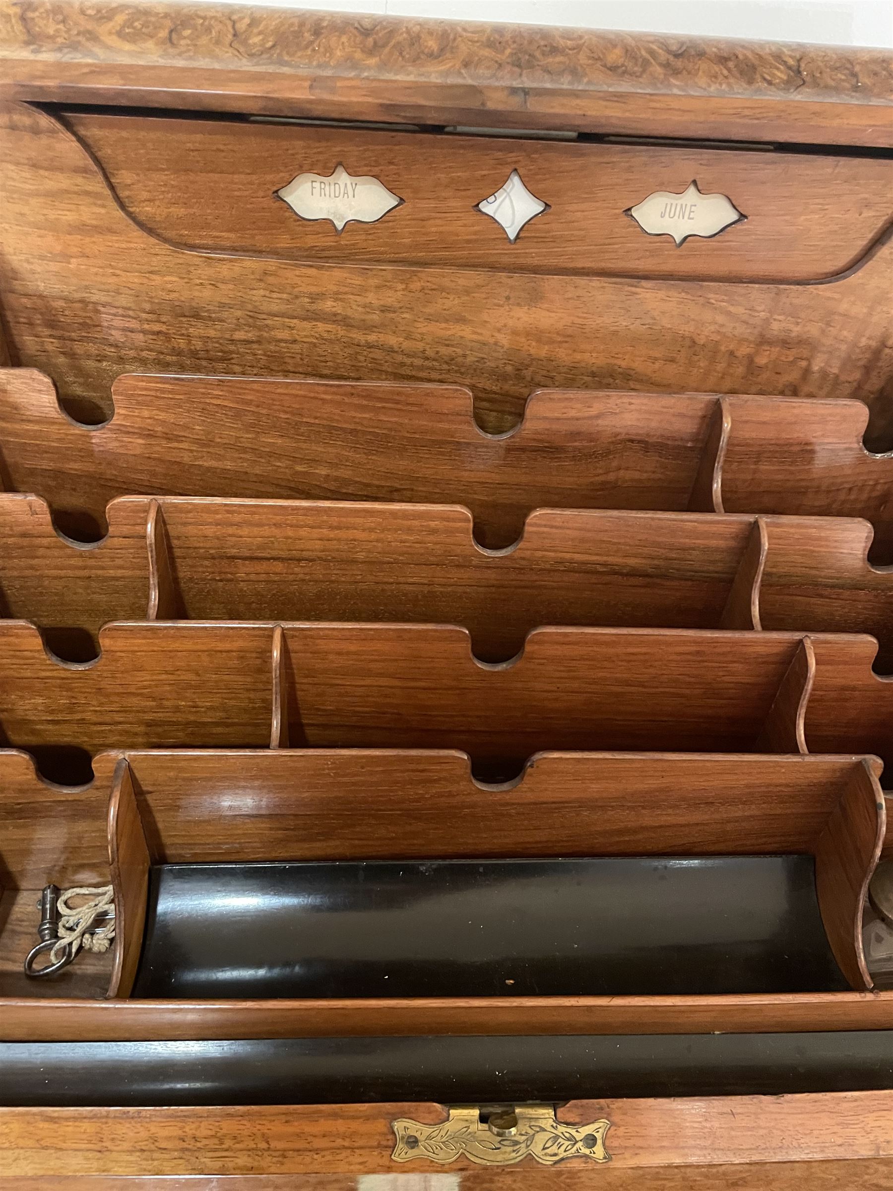 19th century burr walnut correspondence box, the sloped front opening to reveal a fitted interior with perpetual calendar, letter racks, and pen tray between two inkwell recesses, above a pull out draw with recessed brass handle, H41cm L40.5cm D28.5cm