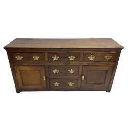 George III country oak dresser base,  rectangular top over with three central drawers flanked by two drawers and two panelled cupboards, each with moulded fronts, on stile feet