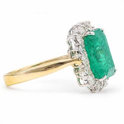 18ct gold emerald and diamond cluster ring, single octagonal cut emerald of approx 3.80 carat, surrounded by sixteen round brilliant cut diamonds, hallmarked, total diamond weight approx 0.50 carat