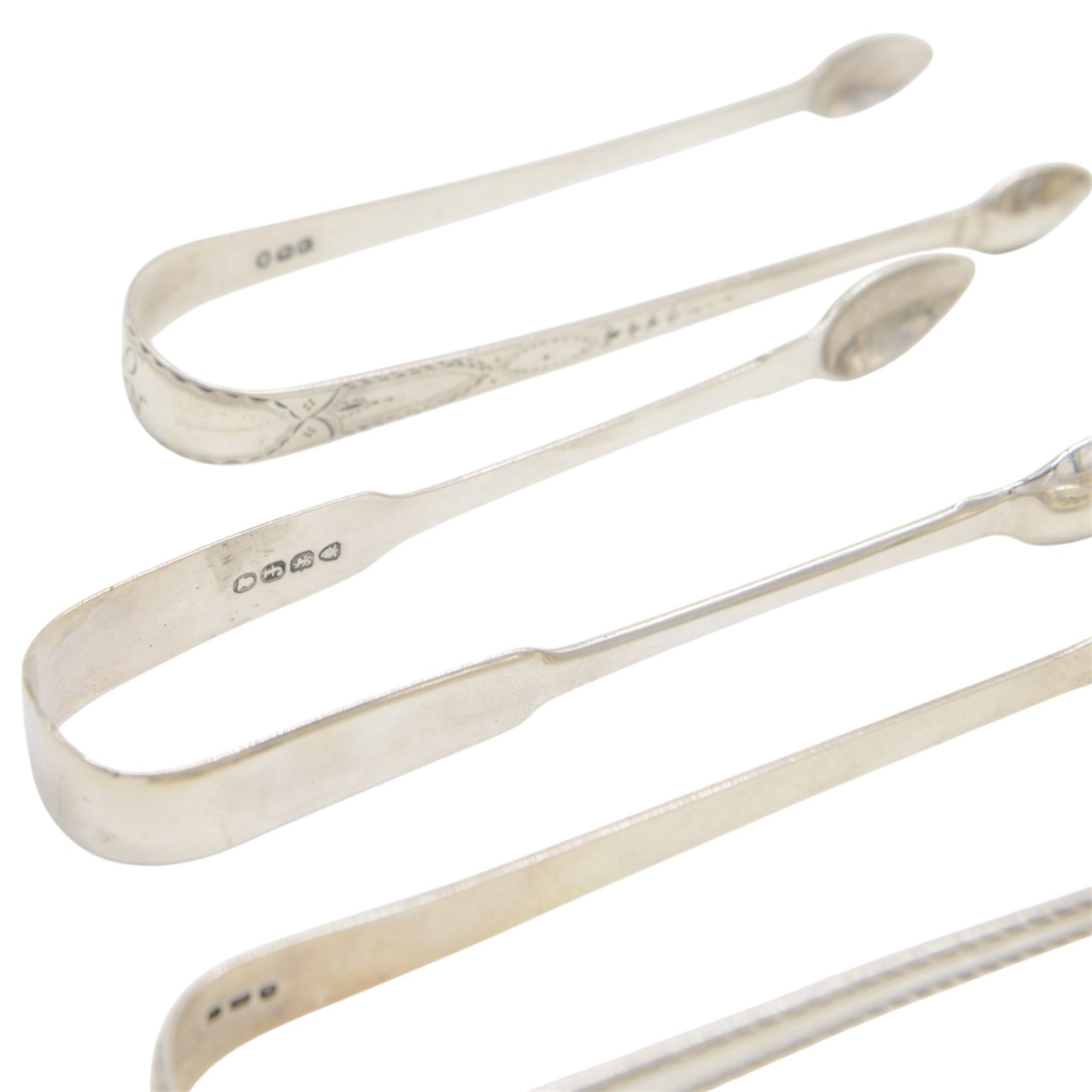 Collection of silver napkin rings and flatware, including set of Chinese bamboo design teaspoons with character mark finials, stamped 90, three pairs of Georgian and later sugar tongs, Scottish silver mustard spoon, hallmarked W S Junior, Glasgow 1833, cruet spoons, coffee spoons, etc, all stamped or hallmarked 