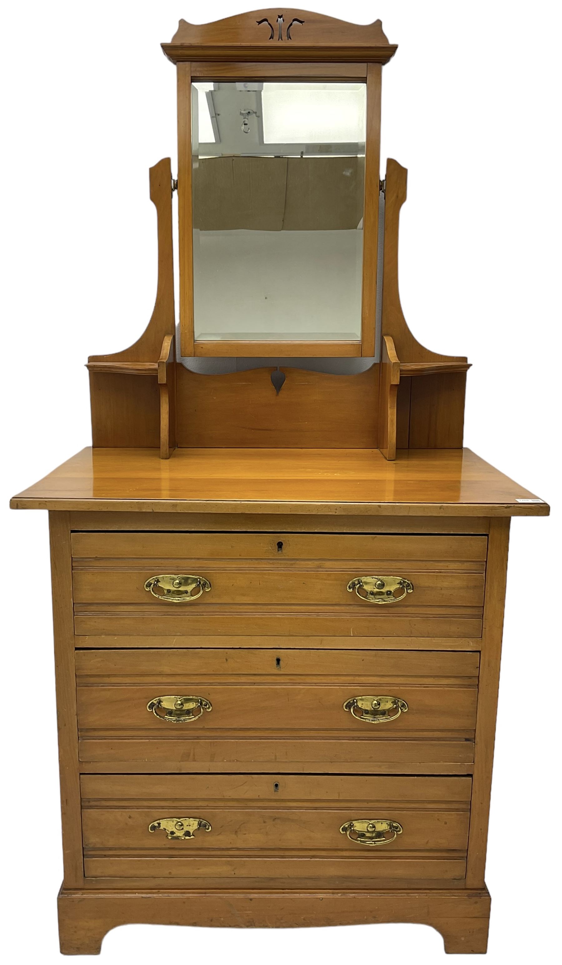 Edwardian satin walnut dressing chest, raised bevelled mirror back, the base fitted with three drawers