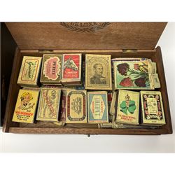Large collection of matchboxes, together with a large quantity of silver plated souvenir spoons, in a vintage suitcase
