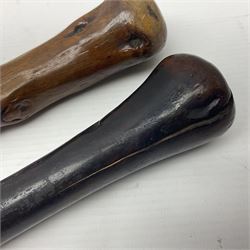 Two wooden walking sticks, both with comparts that would have housed horse measures, H88cm