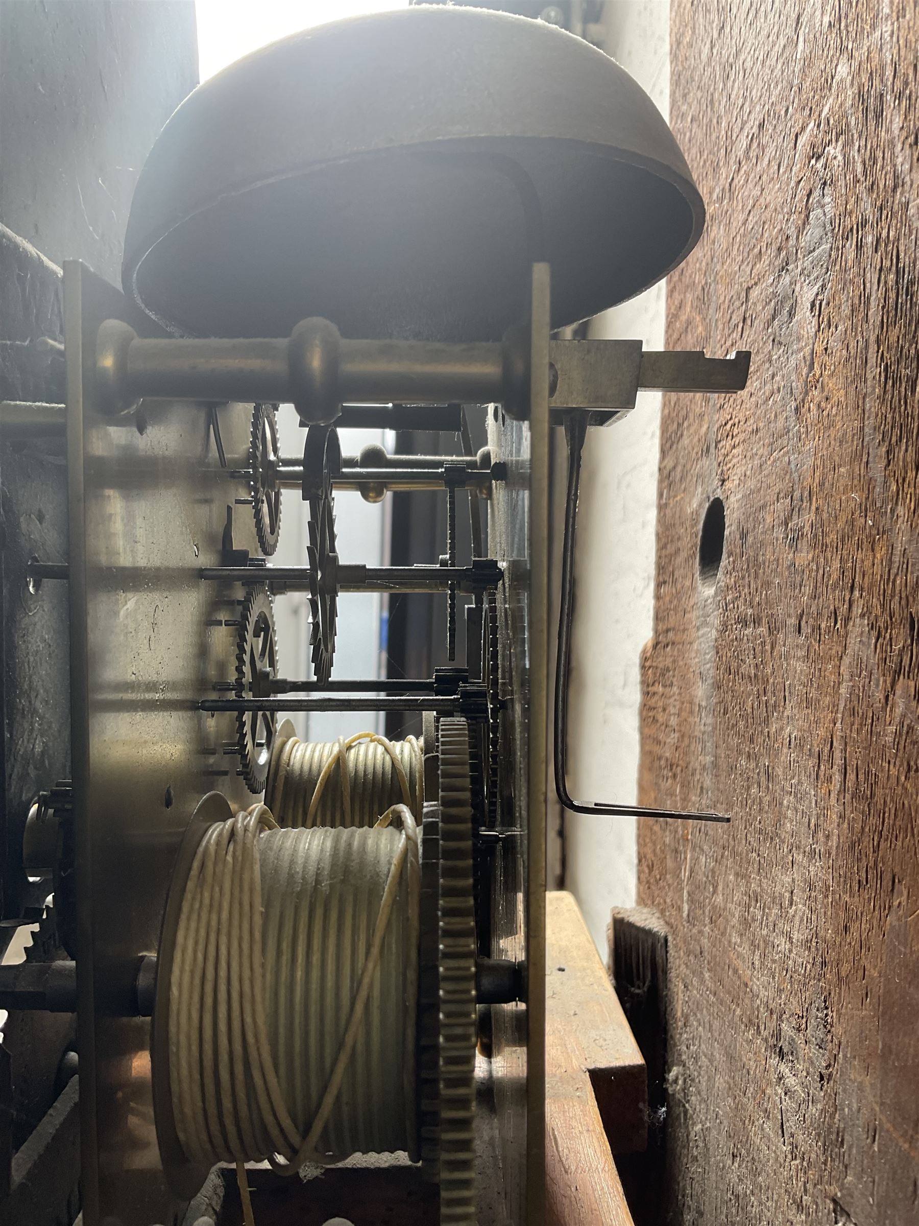 Oak and Mahogany - 8-day longcase clock c1830 with a swan necked pediment and break arch hood door beneath flanked by reeded pilasters with Corinthian capitals,  trunk with three quarter reeded columns and a short door with canted corners, on a conforming plinth with a raised panel, painted dial with Arabic numerals, painted birds to the spandrels and a depiction of a soldier and encampment to the arch, with subsidiary calendar aperture and seconds dial, makers name indistinct, with a rack striking movement striking the hours on a bell.  No weights or pendulum.
