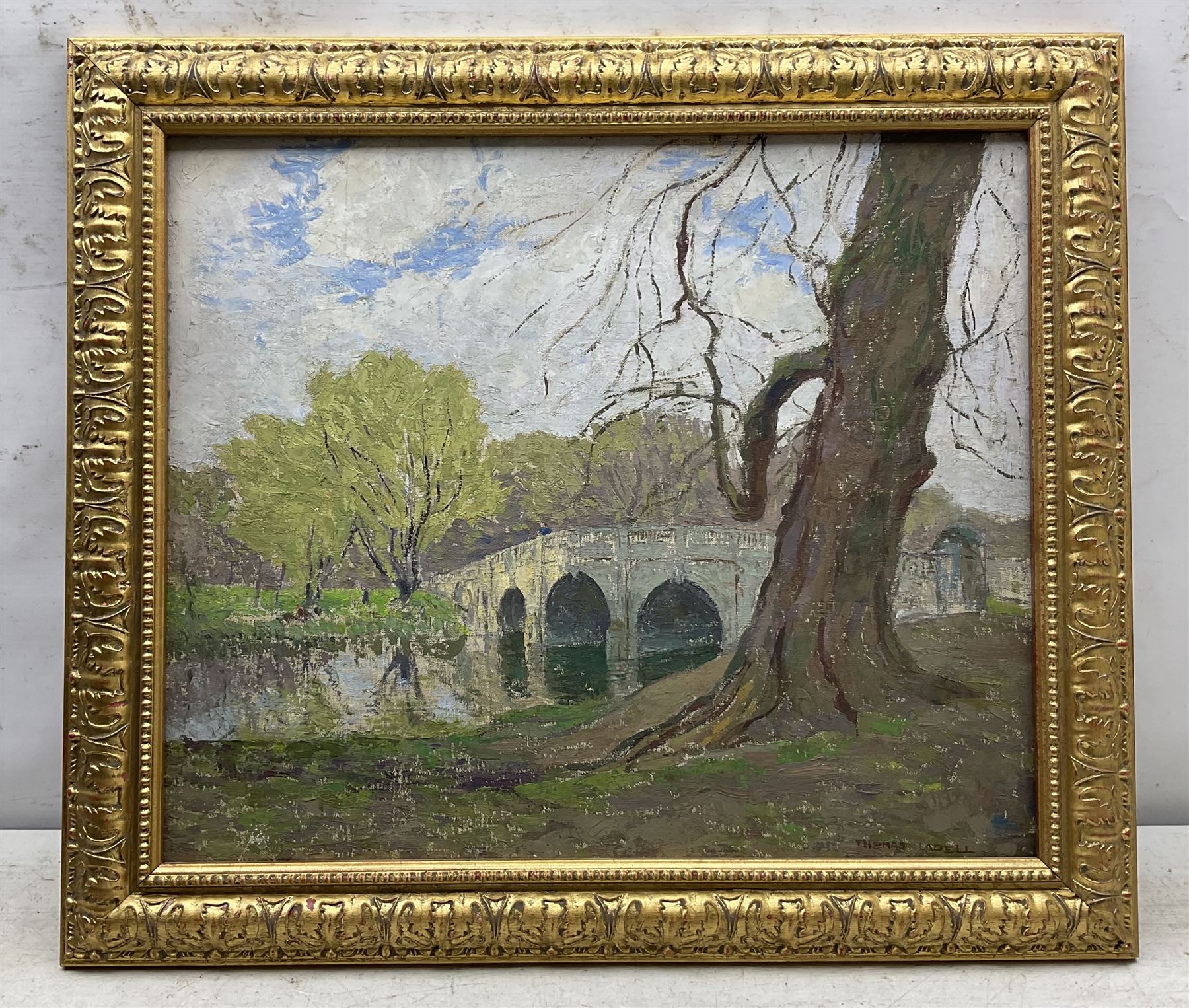 Thomas La Dell (British 1883-1971): Country Park with Stone Bridge, oil on canvas board signed 41cm x 49cm 
Notes: Thomas was the father of Thomas Edwin La Dell ARA (1914-1970), he is listed as a 'Sheffield-born bookbinder' and 'still life painter' along with his wife Ellen. He exhibited at the Royal Academy between 1949-1967; his inaugural exhibit in 1949 was entitled 'The Old Elm' (No.938), which, owing to the James Bourlett label verso, may well be the present lot