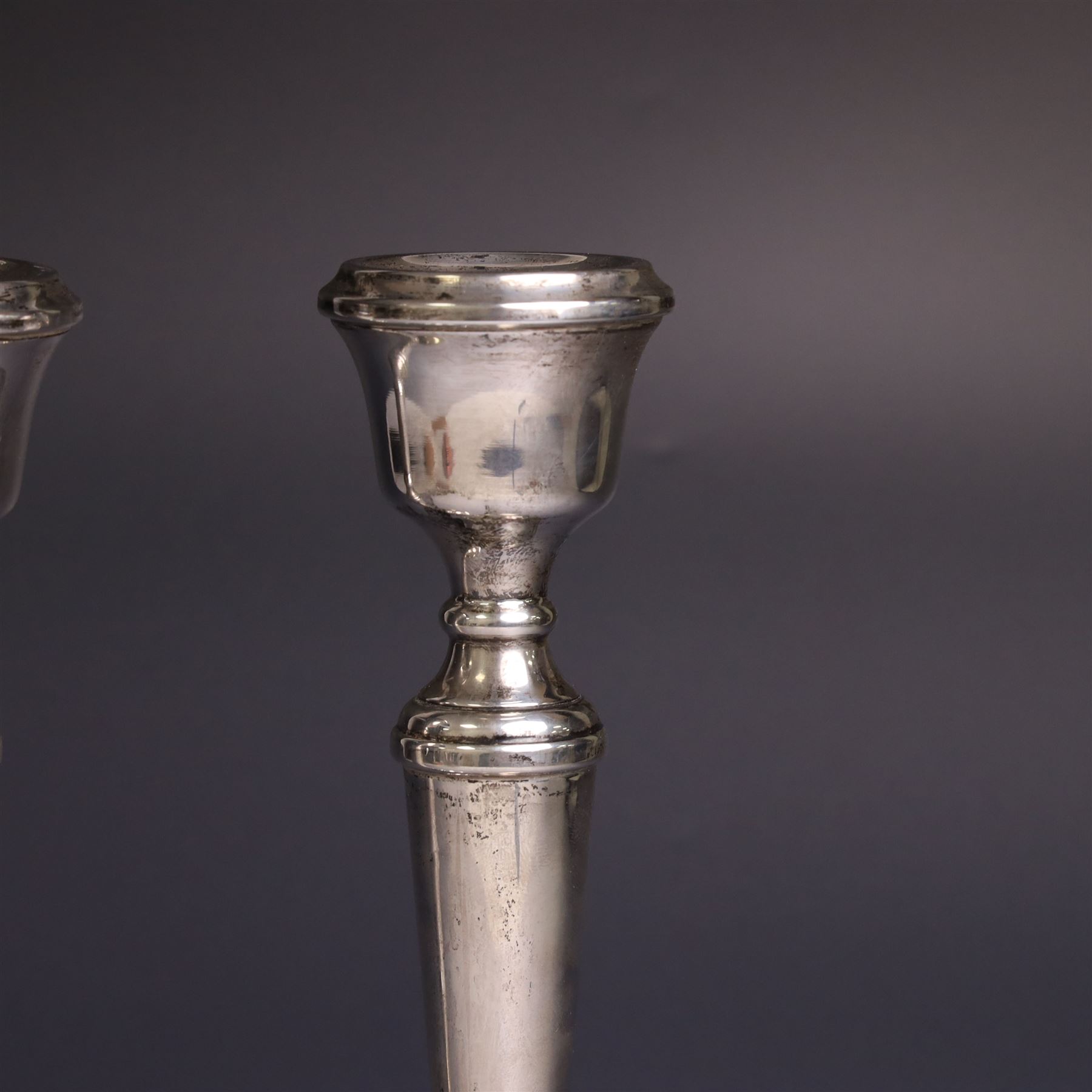 Pair of late 20th century silver candlesticks, each with tapering stem and upon circular beaded weigthed foot, hallmarked A T Cannon Ltd, Birmingham 1970, H21cm