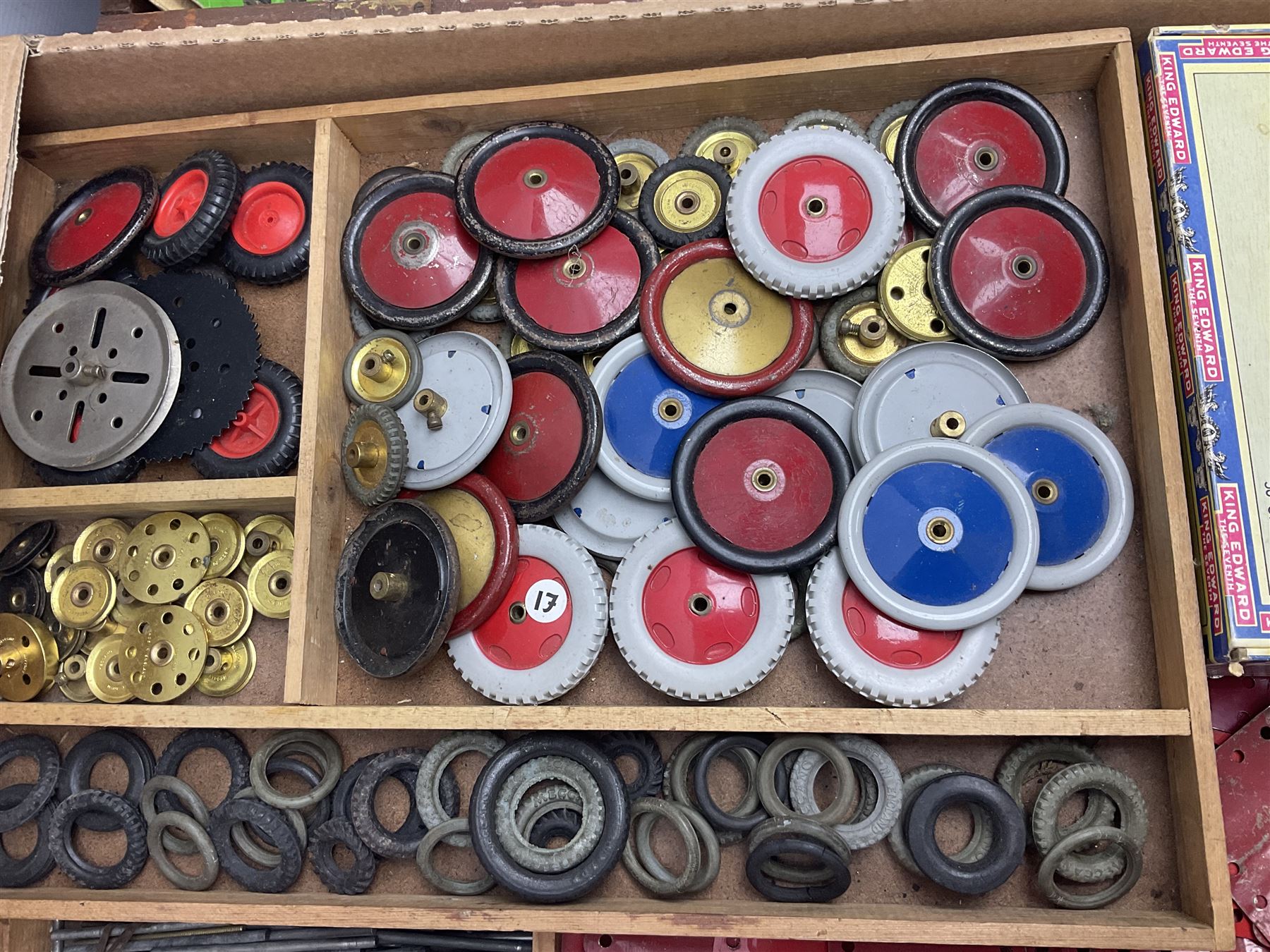 Meccano - large quantity of loose parts including various plates and strips, flanged plates, pulleys, axle rods and crank handles, wheels and tyres, gear wheels, brackets, nuts & bolts, various manuals; predominantly red and green; some in compartmentalised wooden trays