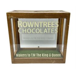 Rowntree's Chocolates oak display cabinet with glazed panels, the front with later painted lettering, the reverse with sliding panel, H38.5cm W41.5cm D19cm