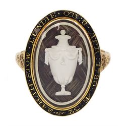George III gold mourning ring, the bezel enclosing a lock of plaited hair under a reverse white painted urn glass panel, the black enamel border inscribed 'Sarah Stow Lundie OB 8 Apr 1780 AE 32'