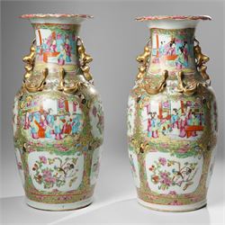 Cantonese famille rose vases, of inverted baluster form, the domed cover with gilt dog of Fu finial, H38cm; together with a further pair of Cantonese vases, each with double Buddhist lion handles and applied at the shoulders with chilong, H45cm (3)