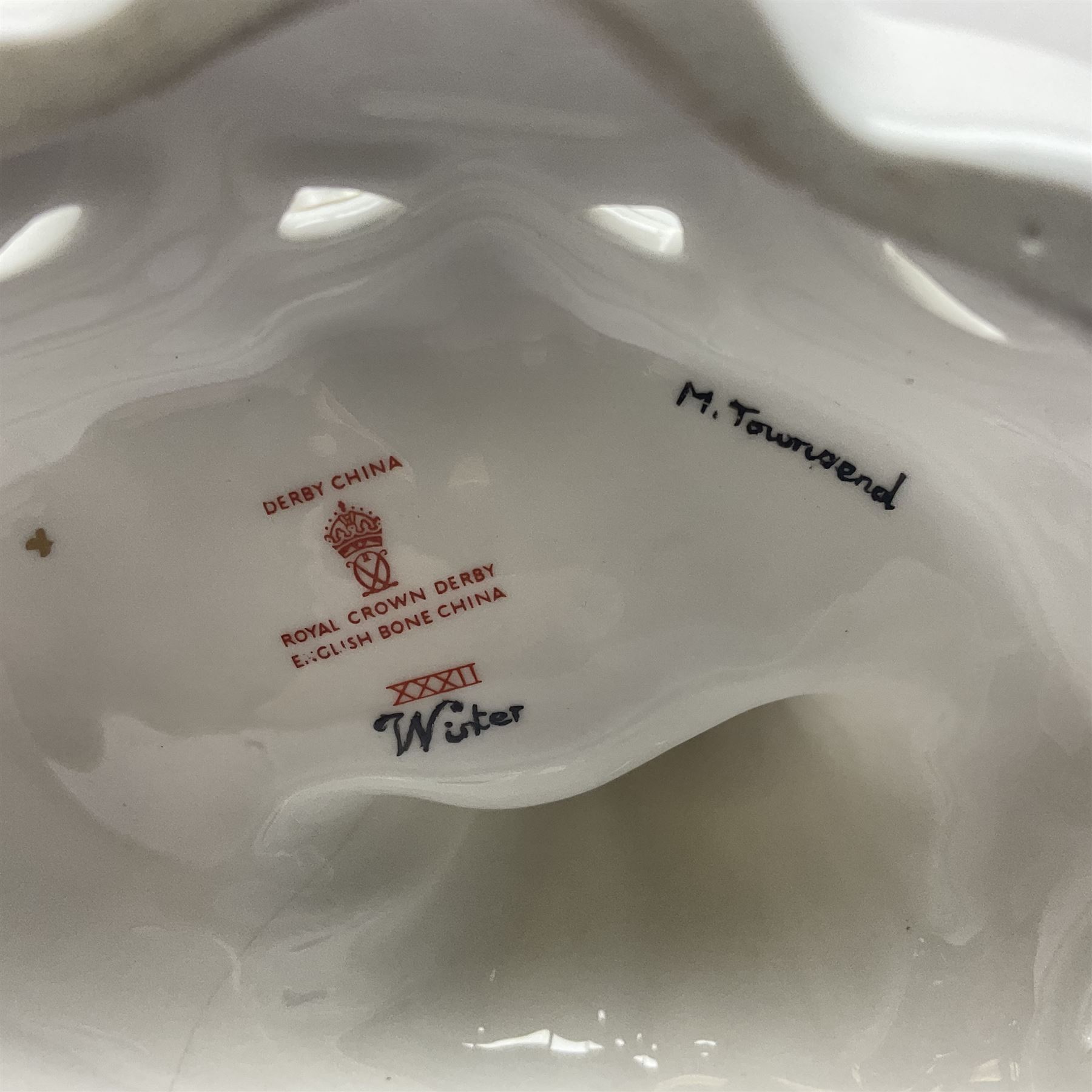 Royal Crown Derby figurine, Winter, modelled as a man with crossed arms on ice skates, by M. Townsend, with printed marks beneath, H24cm