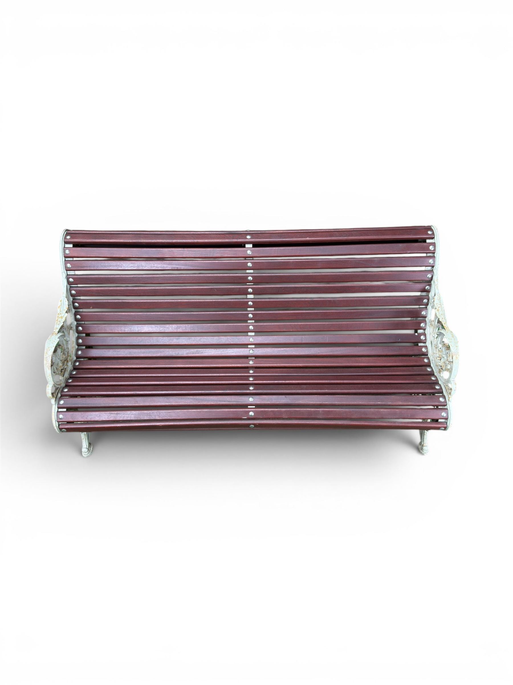 Large late Victorian cast iron garden bench, serpentine form with scroll back and seat, slatted with mahogany stained Sapele