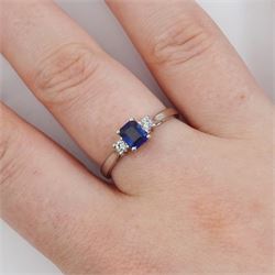 Platinum three stone emerald cut sapphire and round brilliant cut diamond ring, hallmarked, sapphire approx 0.50 carat, total diamond weight approx 0.15 carat