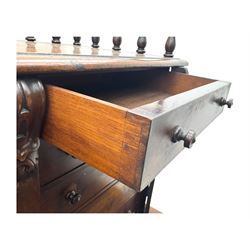 Large Victorian mahogany Registry/Dickens’ desk, spindle gallery top, one side with five small drawers and the other with blind cupboard drawer, revealing pigeon holes with scroll carved locking side bars on either side, above a hinged and leathered writing slope with three drawers and pigeon holes underneath, above a central locking drawer with key, the pedestals each with four drawers and  turned knob handles, separates into four parts for transport