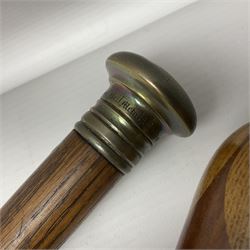 Three early 20th century walking sticks, to include a smoking pipe walking stick, the cane opening to reveal a concealed pipe, and a wooden walking cane, the metal cover with inscription 'bell metal and wood of York Minster, Burnt May 20 1840, and a turned wooden walking stick, with marquetry checkerboard pommel, tallest L90cm