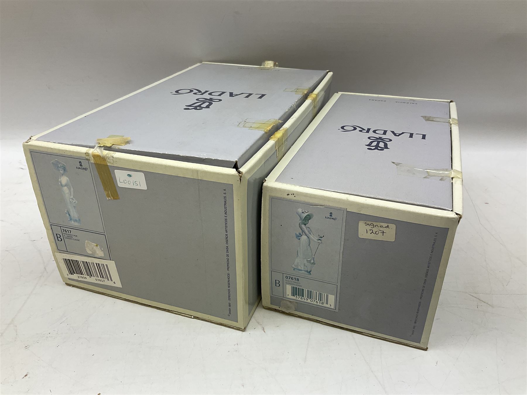 Two Lladro figures, comprising Garden Classic, no 7617 and Garden Song, no 7618, with original boxes and artists signature beneath, largest example H23cm