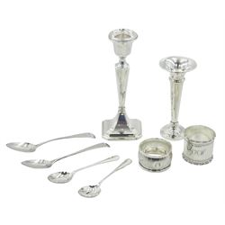 Group of assorted silver, comprising small silver mounted candlestick with weighted base, hallmarked Clark & Sewell, Birmingham 1917, H15cm, a modern silver mounted specimen vase of trumpet form, hallmarked P H Vogel & Co, Birmingham 1972, two 1920's silver napkin rings, the largest example hallmarked Eugene Leclere, Sheffield 1921, the second hallmarked William Hair Haseler, Birmingham 1924, pair of Georgian teaspoons, and pair of 1920's coffee spoons, approximate weighable silver 3.02 ozt (94 grams)