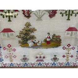 Victorian wool work sampler, depicting a vignette of a young girl feeding birds, flanked by two houses, and surrounded by urns of flowers and flowering plants, within a fruiting vine border, in maple frame, overall H47.5cm W49.5cm