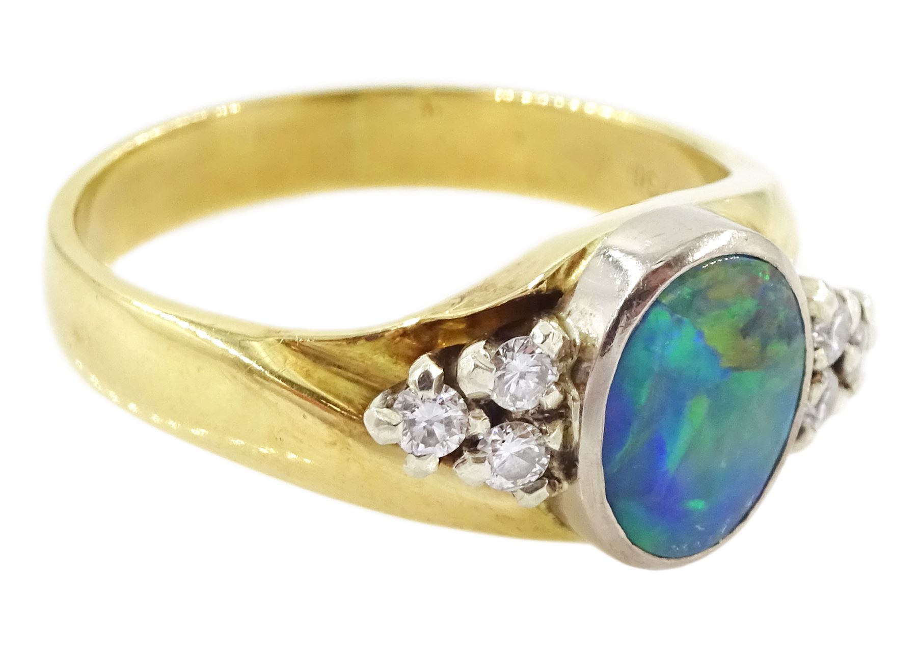 18ct gold opal and diamond ring, single oval cut opal, with three round brilliant cut diamonds set either side, stamped 750, total diamond weight approx 0.20 carat